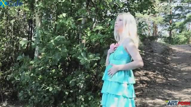 Slim blonde angel wearing blue dress May touches herself by the lake