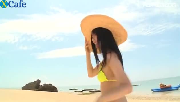 Svelte Japanese cutie runs around the beach in tiny yellow bikini